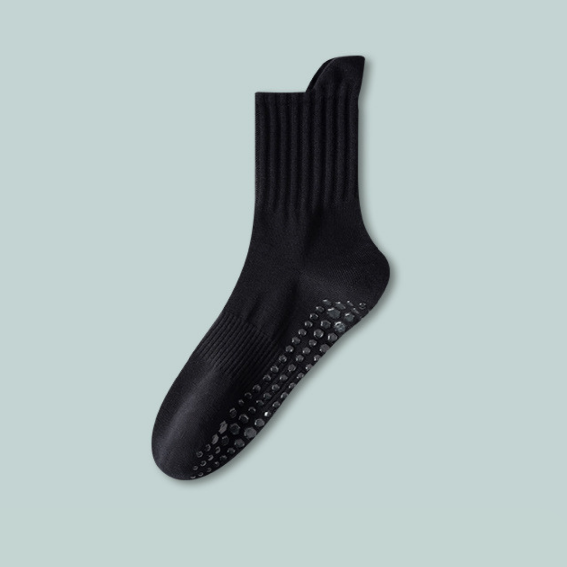 Black sock with textured sole on a light blue background